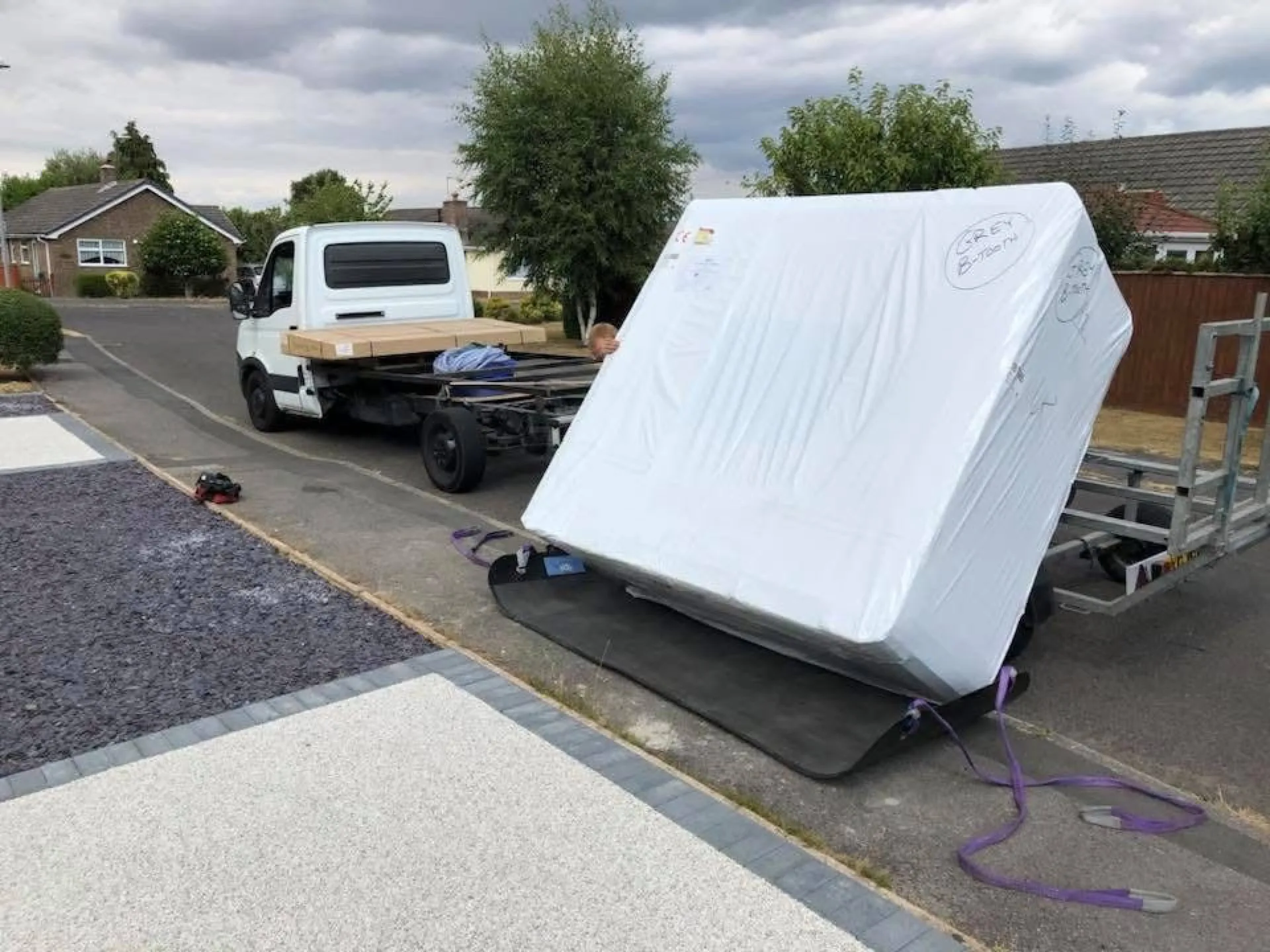 Hot tub being positioned in garden